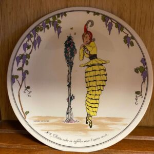 A plate with an image of a woman in a dress.