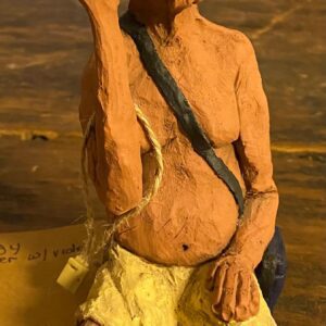 A clay sculpture of an old man with a bag.