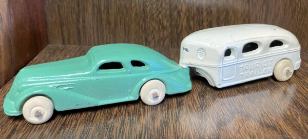 A toy car and trailer are on the table.
