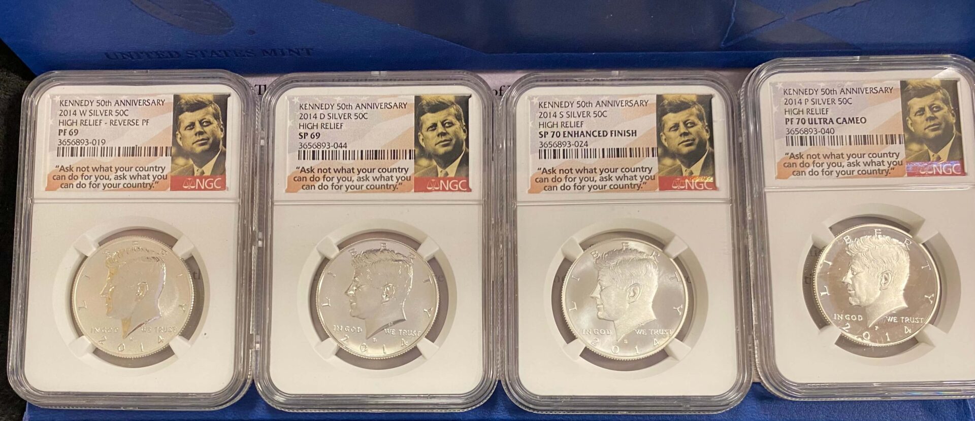 Two silver kennedy half dollars in cases with a picture of john f. Kennedy on the back