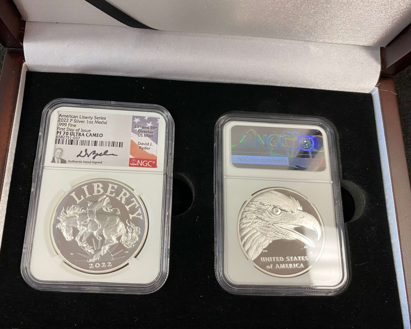 A couple of silver coins sitting on top of a table.
