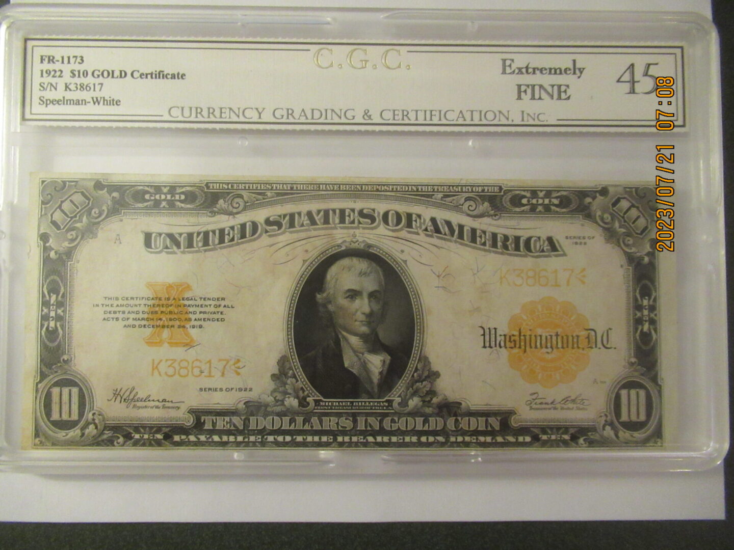 A gold certificate is displayed in front of the frame.