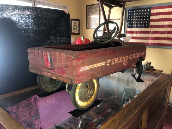 A red wagon sitting on top of a table.