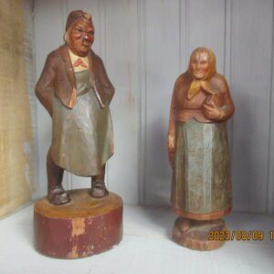 Two wooden figurines of a man and woman.