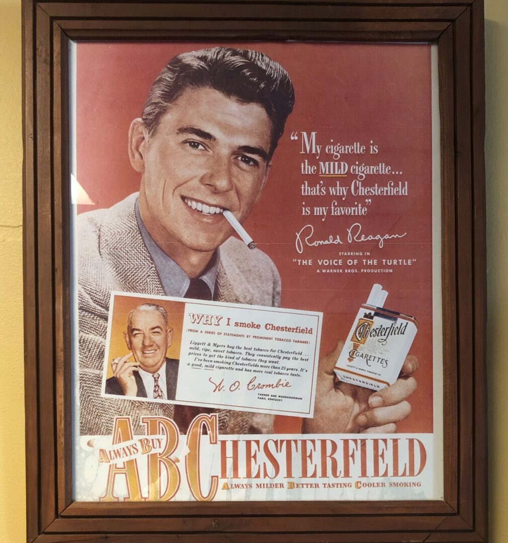 A framed advertisement of ronald reagan for chesterfield cigarettes.