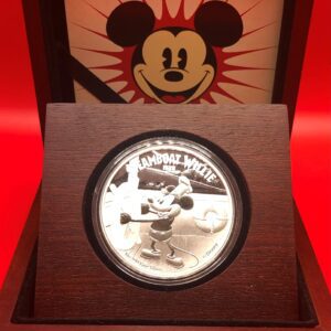 A silver mickey mouse coin in a wooden box.
